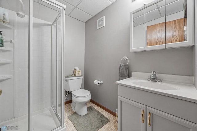 5701 33rd St S, Fargo, ND 58104 - full bathroom with vanity, toilet, a shower stall, a paneled ceiling, and baseboards