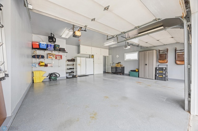 5701 33rd St S, Fargo, ND 58104 - garage featuring a garage door opener and freestanding refrigerator