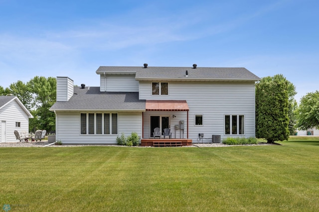 5701 33rd St S, Fargo, ND 58104 - back of house featuring cooling unit, a lawn, and a chimney