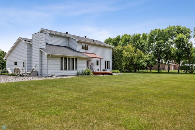 5701 33rd St S, Fargo, ND 58104 - back of property with a lawn, a wooden deck, and roof with shingles