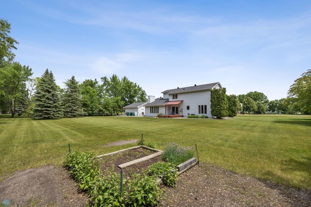5701 33rd St S, Fargo, ND 58104 - view of green lawn featuring a garden