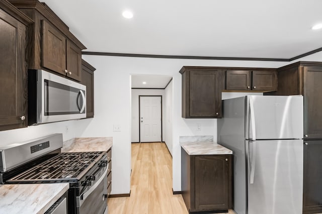 215 Mckay Ave # 42, Alexandria, MN 56308 - kitchen featuring appliances with stainless steel finishes, dark brown cabinets, crown molding, light countertops, and recessed lighting