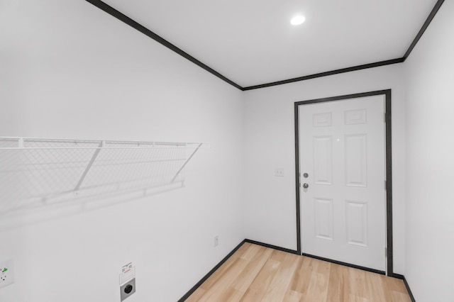 215 Mckay Ave # 42, Alexandria, MN 56308 - washroom featuring light wood-style floors, ornamental molding, hookup for an electric dryer, and baseboards