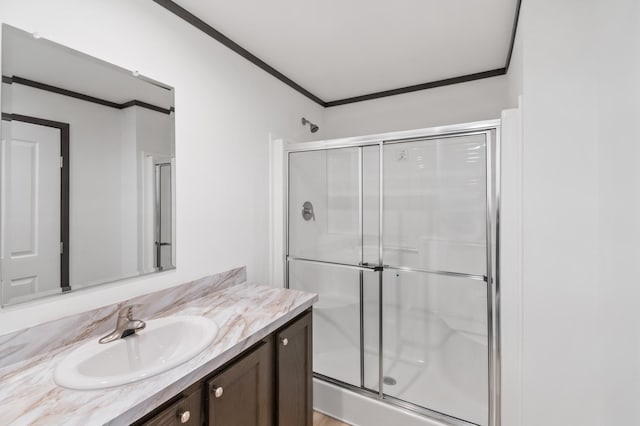 215 Mckay Ave # 42, Alexandria, MN 56308 - bathroom featuring ornamental molding, vanity, and a shower stall