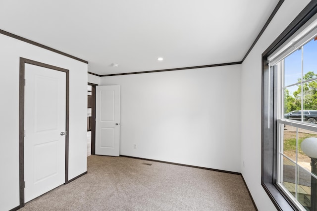 215 Mckay Ave # 42, Alexandria, MN 56308 - unfurnished bedroom featuring light carpet, baseboards, ornamental molding, and recessed lighting