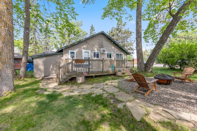 30203 Circle Dr, Breezy Point, MN 56472 - back of house with a fire pit, a wooden deck, and a lawn