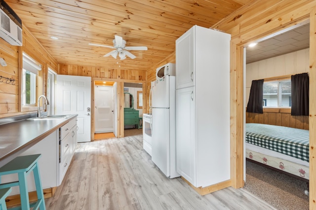 30203 Circle Dr, Breezy Point, MN 56472 - kitchen with white appliances, white cabinets, a sink, wooden ceiling, and wood walls