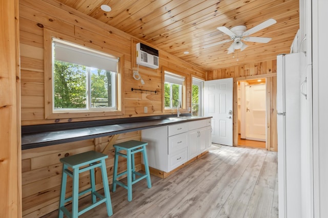30203 Circle Dr, Breezy Point, MN 56472 - kitchen with a sink, white cabinetry, dark countertops, freestanding refrigerator, and wood ceiling