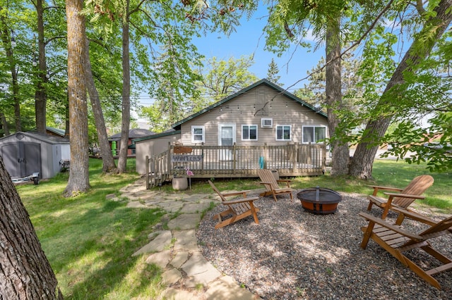 30203 Circle Dr, Breezy Point, MN 56472 - back of house featuring an outdoor fire pit, a wooden deck, and a lawn