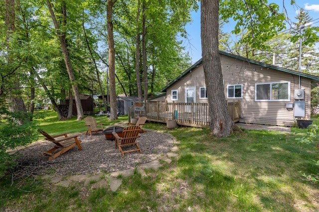 30203 Circle Dr, Breezy Point, MN 56472 - view of green lawn with an outdoor fire pit and a deck
