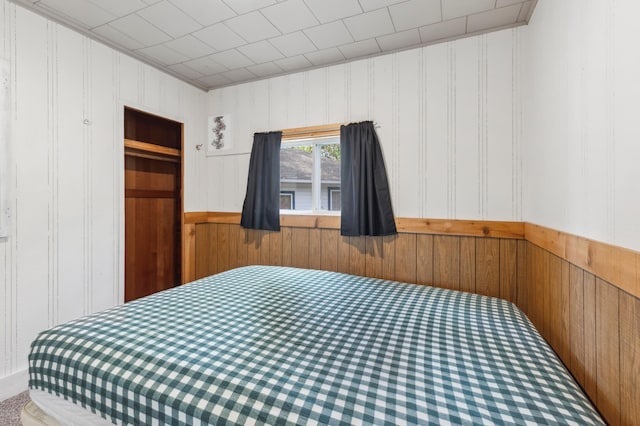 30203 Circle Dr, Breezy Point, MN 56472 - bedroom with wood walls, carpet floors, and wainscoting