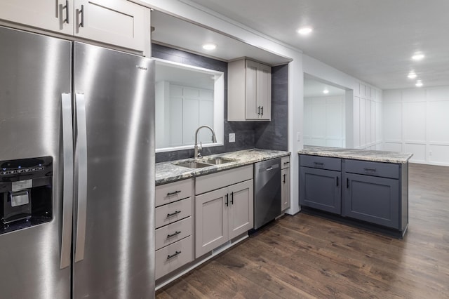 1020 1st St S, Cold Spring, MN 56320 - kitchen with appliances with stainless steel finishes, a sink, dark wood-type flooring, light stone countertops, and recessed lighting