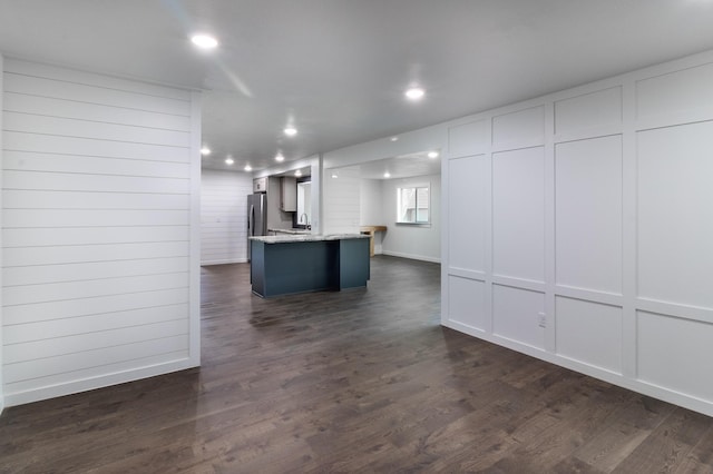 1020 1st St S, Cold Spring, MN 56320 - kitchen featuring a decorative wall, recessed lighting, dark wood-type flooring, white cabinetry, and light stone countertops