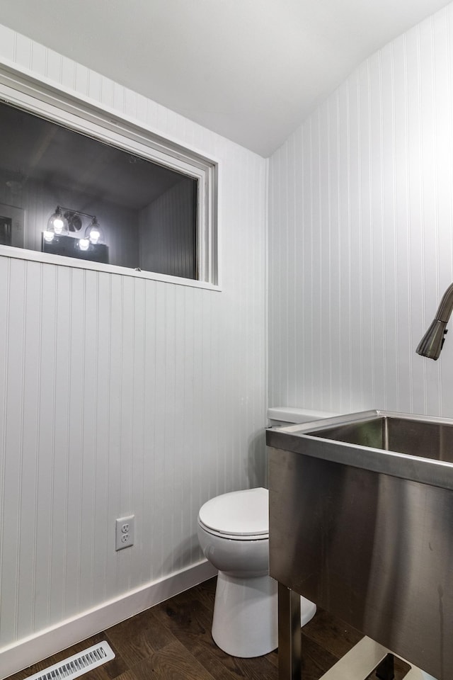 1020 1st St S, Cold Spring, MN 56320 - bathroom with toilet, wood finished floors, a sink, and baseboards