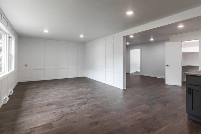 1020 1st St S, Cold Spring, MN 56320 - spare room with a decorative wall, recessed lighting, and dark wood-style flooring