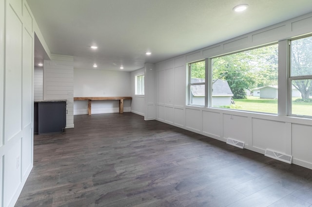 1020 1st St S, Cold Spring, MN 56320 - empty room with a decorative wall, dark wood-type flooring, and recessed lighting