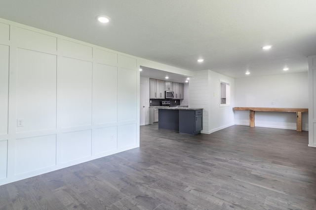 1020 1st St S, Cold Spring, MN 56320 - unfurnished living room with dark wood-type flooring, recessed lighting, and baseboards