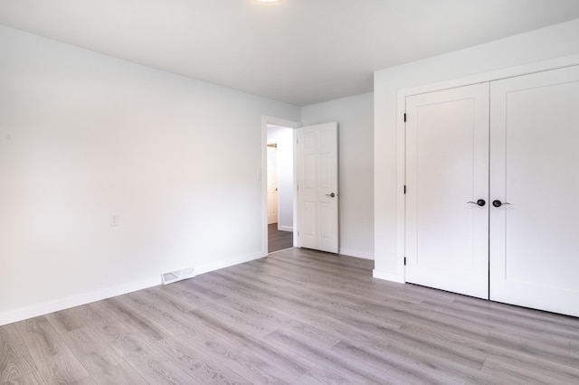 1020 1st St S, Cold Spring, MN 56320 - unfurnished bedroom with light wood-type flooring, baseboards, and a closet
