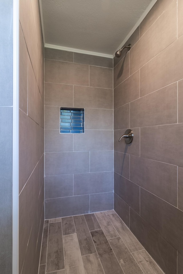 1020 1st St S, Cold Spring, MN 56320 - bathroom featuring a tile shower and wood finished floors