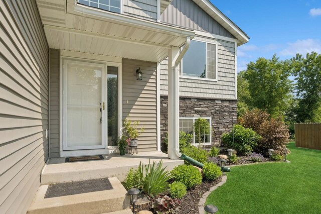 13362 Jefferson St, Becker, MN 55308 - property entrance featuring stone siding and a lawn