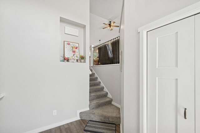 13362 Jefferson St, Becker, MN 55308 - staircase featuring wood finished floors, ceiling fan, baseboards, and a high ceiling