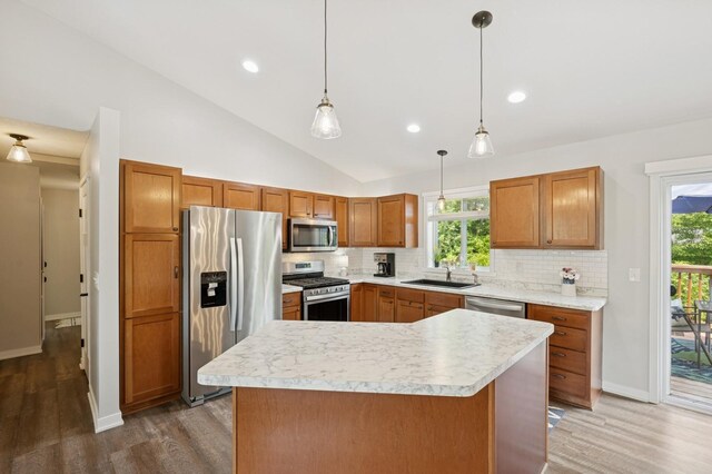 13362 Jefferson St, Becker, MN 55308 - kitchen featuring appliances with stainless steel finishes, a sink, wood finished floors, vaulted ceiling, and tasteful backsplash