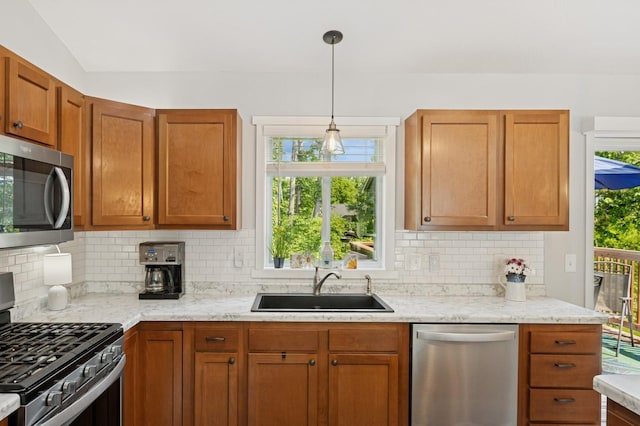 13362 Jefferson St, Becker, MN 55308 - kitchen featuring appliances with stainless steel finishes, a sink, decorative backsplash, and decorative light fixtures