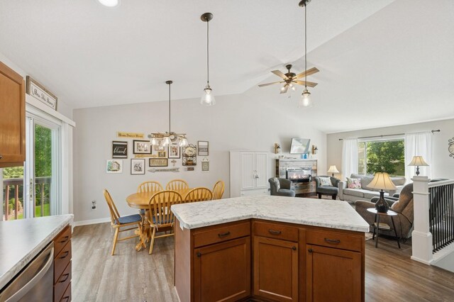 13362 Jefferson St, Becker, MN 55308 - kitchen with stainless steel dishwasher, wood finished floors, lofted ceiling, light countertops, and decorative light fixtures