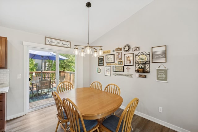 13362 Jefferson St, Becker, MN 55308 - dining space featuring wood finished floors, a chandelier, baseboards, and vaulted ceiling