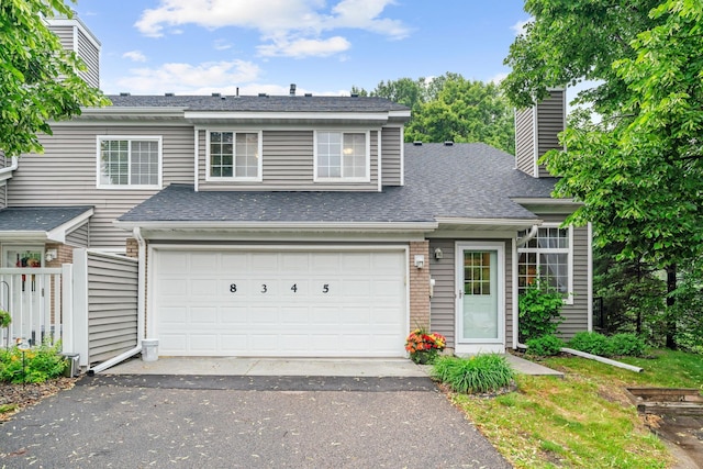 8345 Corcoran Cir Unit 42, Inver Grove Heights, MN 55076 - view of front of home with a chimney, driveway, and a shingled roof