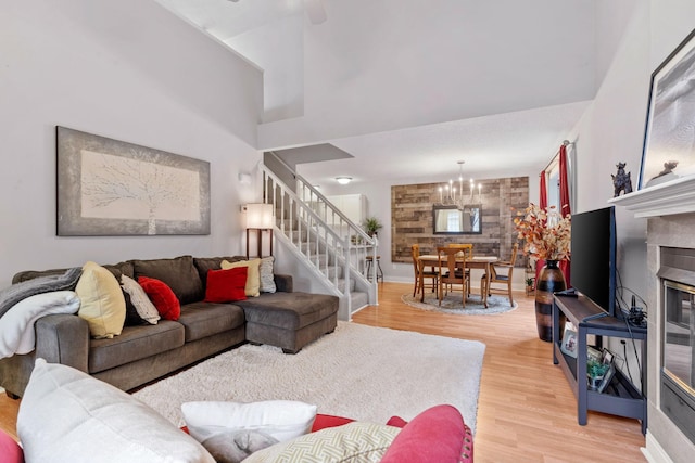 8345 Corcoran Cir Unit 42, Inver Grove Heights, MN 55076 - living room featuring light wood-style floors, stairway, a chandelier, baseboards, and a towering ceiling