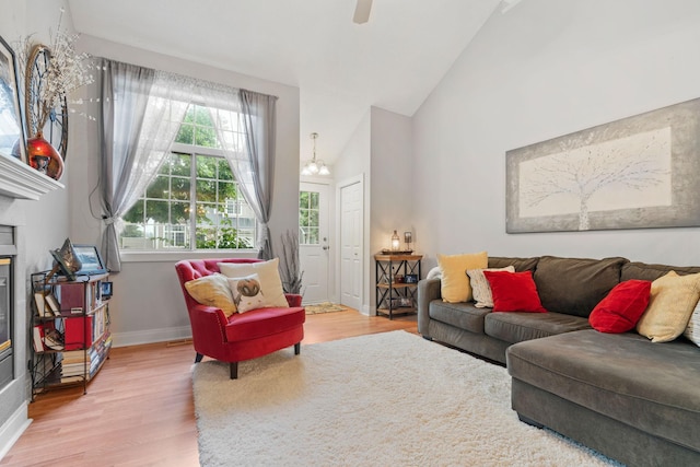 8345 Corcoran Cir Unit 42, Inver Grove Heights, MN 55076 - living area featuring light wood-type flooring, baseboards, high vaulted ceiling, a chandelier, and ceiling fan