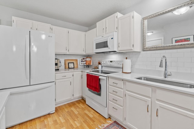 8345 Corcoran Cir Unit 42, Inver Grove Heights, MN 55076 - kitchen with white appliances, a sink, light countertops, decorative backsplash, and a textured ceiling