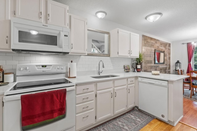 8345 Corcoran Cir Unit 42, Inver Grove Heights, MN 55076 - kitchen featuring white appliances, a sink, a textured ceiling, light countertops, and white cabinets