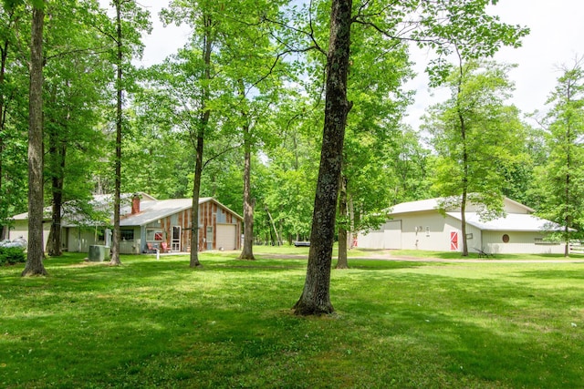 19214 County Road 12, Irondale Twp, MN 56455 - view of grassy yard featuring a garage