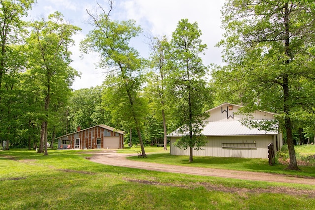 19214 County Road 12, Irondale Twp, MN 56455 - view of grassy yard with a detached garage, dirt driveway, and an outbuilding
