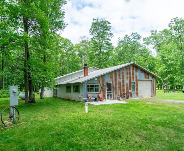 19214 County Road 12, Irondale Twp, MN 56455 - rear view of house with a chimney, a yard, and a patio area