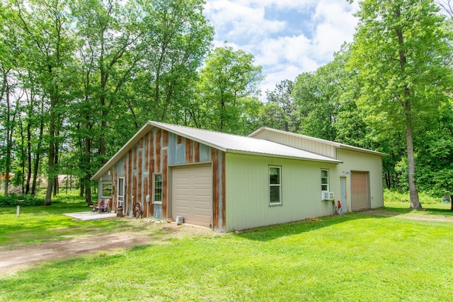 19214 County Road 12, Irondale Twp, MN 56455 - view of side of property featuring a garage, dirt driveway, a lawn, and an outdoor structure