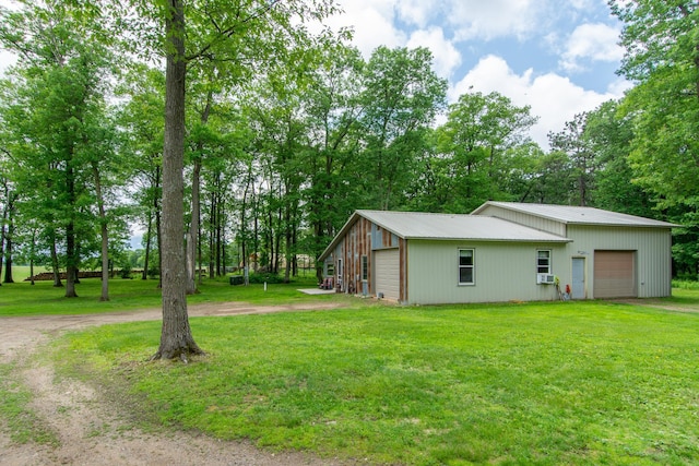 19214 County Road 12, Irondale Twp, MN 56455 - view of side of home featuring a detached garage, dirt driveway, and a yard