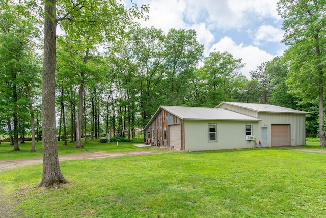19214 County Road 12, Irondale Twp, MN 56455 - view of home's exterior with a garage, a yard, an outdoor structure, and metal roof