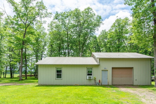 19214 County Road 12, Irondale Twp, MN 56455 - view of front of home with dirt driveway, a front yard, metal roof, and a garage