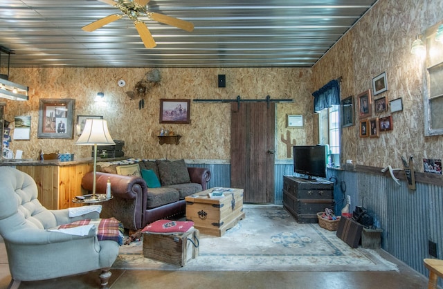 19214 County Road 12, Irondale Twp, MN 56455 - living room with finished concrete floors, a barn door, and ceiling fan
