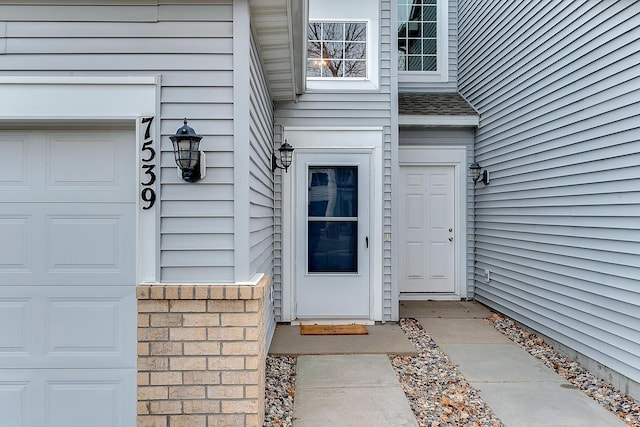 7539 Derby Ln, Shakopee, MN 55379 - doorway to property with a garage and a shingled roof
