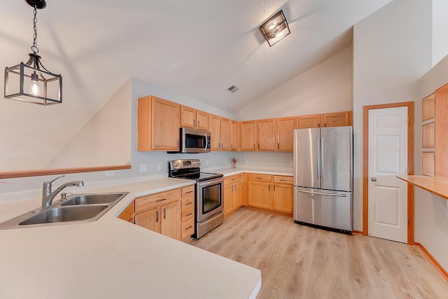 7539 Derby Ln, Shakopee, MN 55379 - kitchen featuring stainless steel appliances, a sink, light brown cabinetry, light wood finished floors, and light countertops
