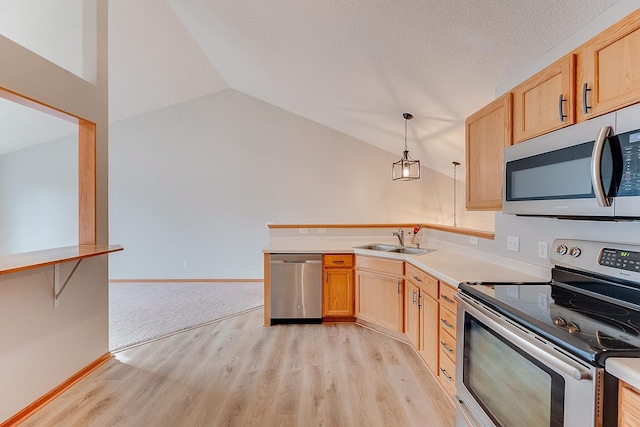 7539 Derby Ln, Shakopee, MN 55379 - kitchen featuring appliances with stainless steel finishes, a sink, lofted ceiling, light wood-type flooring, and light countertops