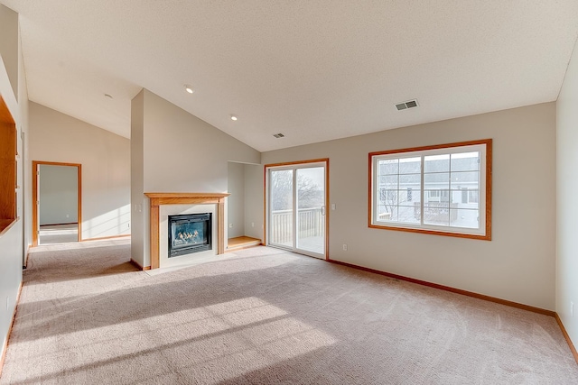 7539 Derby Ln, Shakopee, MN 55379 - unfurnished living room featuring carpet, a glass covered fireplace, baseboards, lofted ceiling, and recessed lighting