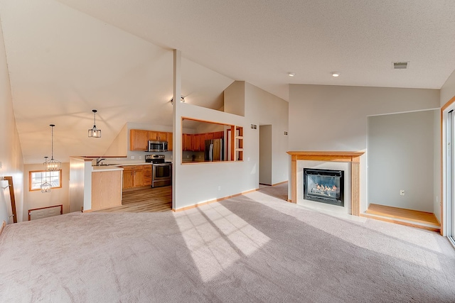 7539 Derby Ln, Shakopee, MN 55379 - unfurnished living room with light colored carpet, a sink, high vaulted ceiling, a glass covered fireplace, and baseboards