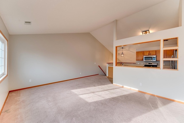 7539 Derby Ln, Shakopee, MN 55379 - unfurnished living room featuring lofted ceiling, light colored carpet, and baseboards