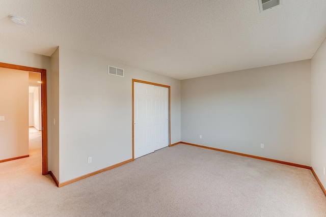 7539 Derby Ln, Shakopee, MN 55379 - unfurnished bedroom featuring light colored carpet, baseboards, a closet, and a textured ceiling