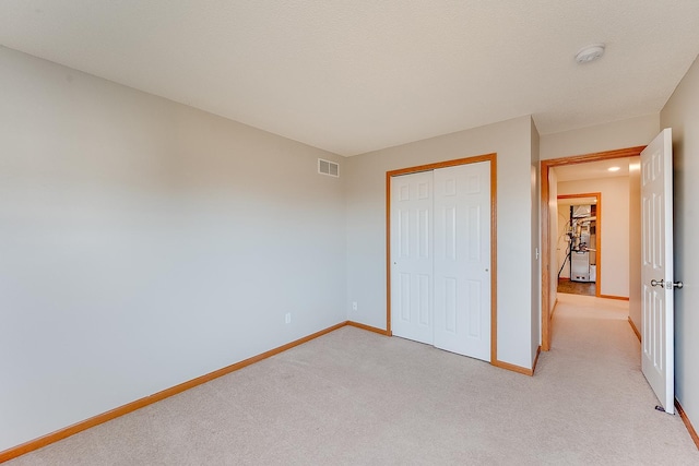 7539 Derby Ln, Shakopee, MN 55379 - unfurnished bedroom with baseboards, light carpet, and a closet